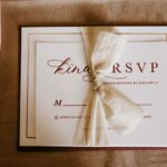 An elegant wedding RSVP invitation card with a tied bow, perfect for a special occasion.