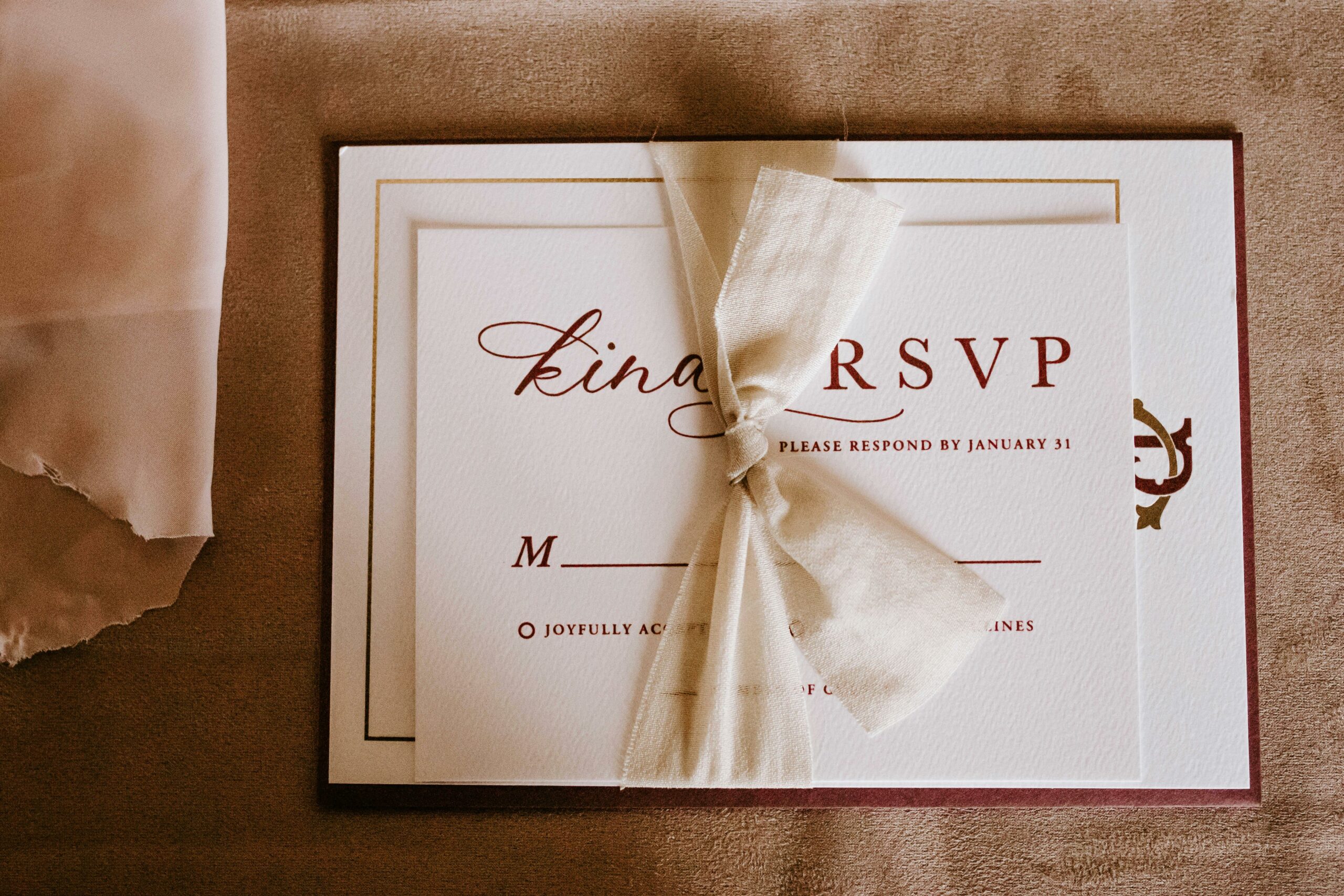 An elegant wedding RSVP invitation card with a tied bow, perfect for a special occasion.